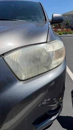 Oxidized, hazy SUV headlight before restoration